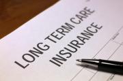 long-term care insurance paperwork with a pen.